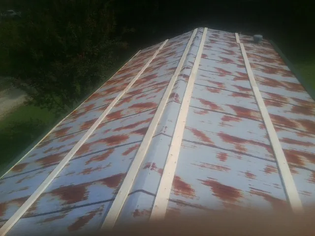 Rusted metal roof panels with new wood purlins before replacement — Storm Damage Roof Repair in Star Junction by Roofing Brothers