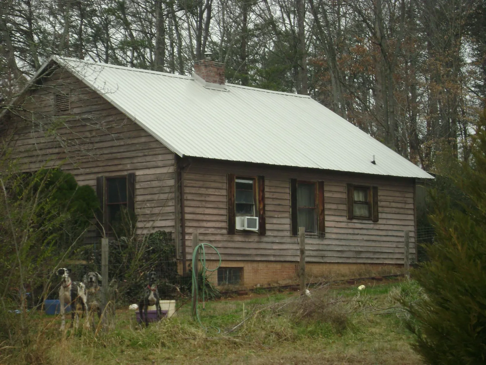 White metal roof on an old wood sided farmhouse, from a Metal Roof Installation job in Star Junction